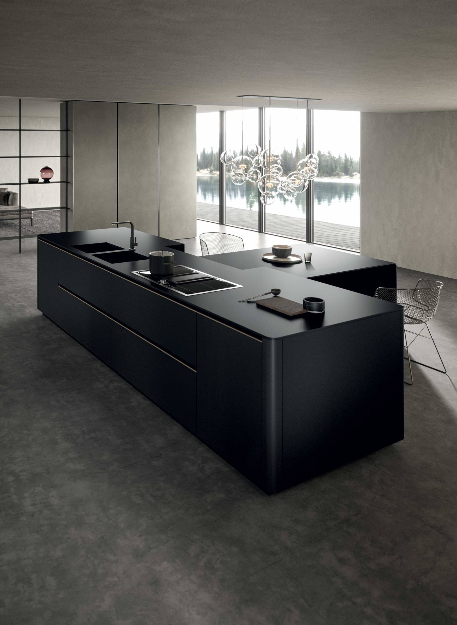 Aussi sobre que sophistiqué, l 'angle  coudé adoucit les formes des îlots et des  tables intégrées de manière à obtenir une  lumière réfléchissant plus naturellement  sur les surfaces